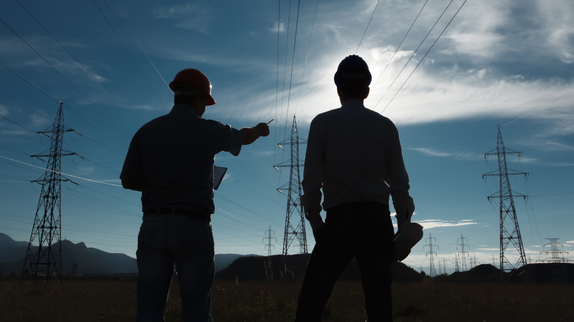 people in hard hats working near power lines